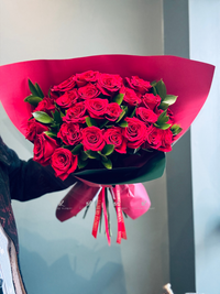 Gorgeous long stem red roses, symbolizing love and passion, with fresh green accents